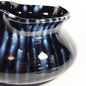 Love the blue drip of the glaze as it travels down the pot.  This is a unique piece of clay pottery