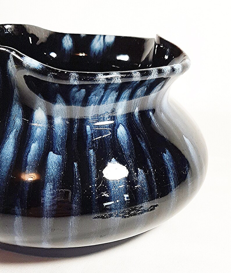 Love the blue drip of the glaze as it travels down the pot.  This is a unique piece of clay pottery