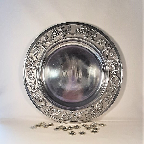 Polished pewter plate with grape design around the rim.  This collectible pewter plate with the fruit design is a perfect mid century touch!