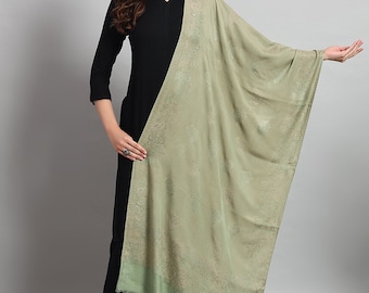 May include: A sage green shawl with a subtle floral pattern. The shawl is made of a soft, lightweight fabric and has a fringed edge.