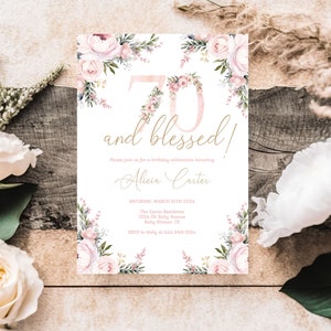 May include: A white invitation card with floral accents and the text "70 and blessed!". The number 70 is decorated with pink flowers. The invitation includes details for a birthday celebration, including the date, location, and RSVP information.