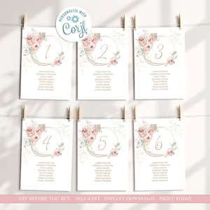 May include: Six wedding table number cards, each with a gold-colored numeral inside a gold circular frame. The frames are decorated with pink roses and greenery. The cards are hanging from wooden clothespins. The text "Personalize with Corjl" is at the top.