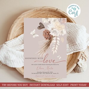 May include: A printable bridal shower invitation with a watercolor floral design in shades of brown, white, and red. The text reads "Showered with love" and includes the bride-to-be's name, the date, time, and location of the event. The invitation is personalized with the text "Registered with Target and Amazon".