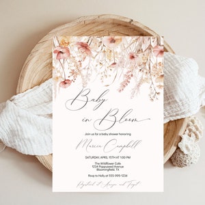 May include: A baby shower invitation featuring a floral design in shades of pink and beige. The text reads "Baby in Bloom" and includes the name "Marcia Campbell". The invitation details the date, time, location, and RSVP information.