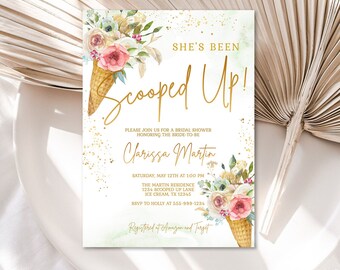 May include: A bridal shower invitation with a watercolor floral design and gold lettering. The invitation reads "She's Been Scooped Up!" and includes the bride-to-be's name, the date, time, and location of the shower. The invitation also includes the text "Registered at Amazon and Target".