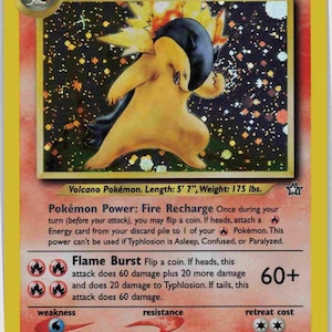 May include: A Pok&eacute;mon trading card featuring Typhlosion, a Stage 2 creature. The card has a yellow border and includes details such as 100 HP and attack information. The illustration shows a yellow and black fiery creature. The card is 170 cm long and weighs 79 kg.