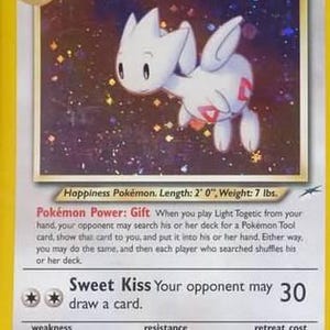 May include: A Light Togetic Pok&eacute;mon trading card. The card features a white Togetic with red markings, set against a starry background. The card has text that includes the Pok&eacute;mon's name, HP, and attack details. The card is 2 feet long and weighs 7 lbs.