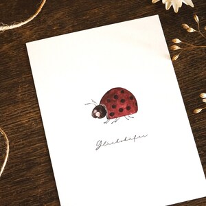 Biglietto di auguri di buona fortuna con coccinella