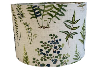 May include: A white lampshade with a green and blue fern pattern.