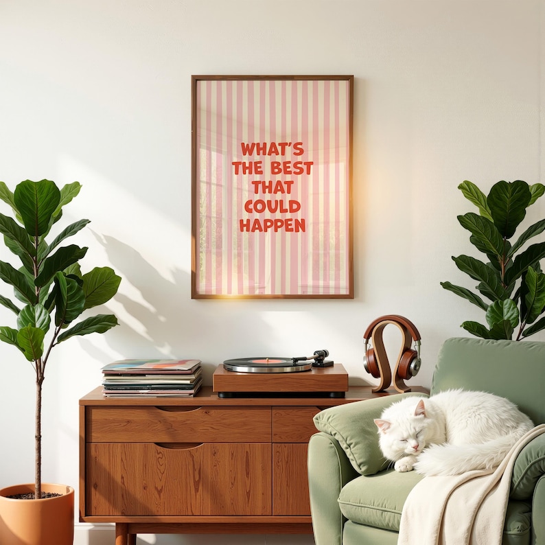 May include: A framed print with the text "WHAT'S THE BEST THAT COULD HAPPEN" hangs above a wooden record player and cabinet. A white cat rests on a green armchair. A pair of brown headphones sits nearby.