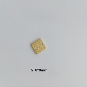 May include: A gold square charm with a small hole in the centre. The charm measures 8mm by 8mm. G 8*8mm is written below the charm.