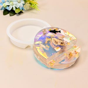 May include: A set of three ceramic mugs with a speckled, matte finish. The mugs are in shades of cream, light gray, and dark gray. Each mug has a simple, minimalist design, perfect for coffee or tea.