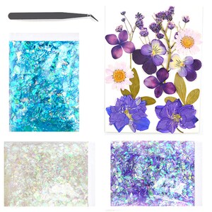 May include: A set of three iridescent glitter flakes in blue, white, and purple, packaged in clear plastic bags. A pair of tweezers is included for applying the glitter.