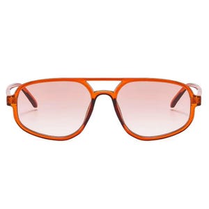 May include: Orange-framed sunglasses with a double bridge and gradient lenses. The lenses transition from a light pink at the bottom to a darker shade at the top. The frames are a translucent orange color.