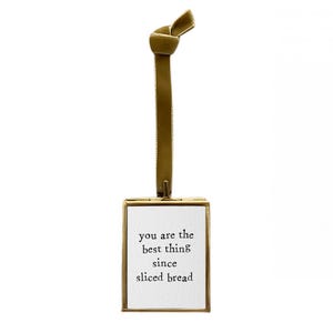 May include: Gold-toned metal frame with a white card inside. The card has the text "You are the best thing since sliced bread" printed in black.