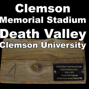 May include: A weathered wooden plaque with the text "Clemson Memorial Stadium Death Valley Clemson University." A smaller plaque reads "Death Valley-Frank Howard Field Original Stadium Seats 1942 to 1972." The wood has visible grain and knots.