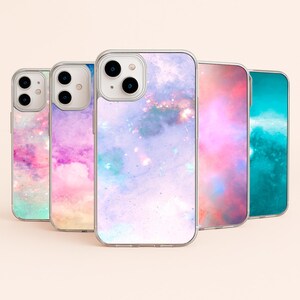 May include: Four clear phone cases featuring a galaxy print. The cases are in shades of pink, purple, blue, and teal.