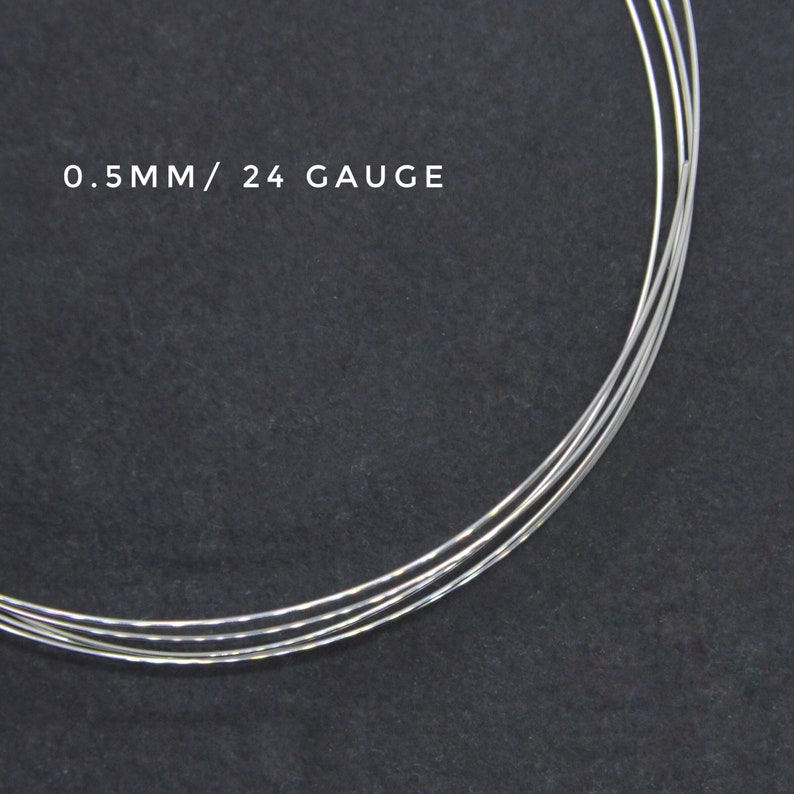 May include: Close-up of silver wire, 0.5mm in diameter, or 24 gauge. The wire is coiled and appears to be for jewelry making.
