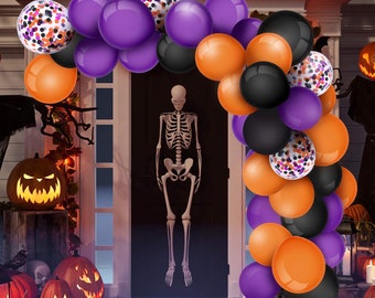 May include: A Halloween party arch made of purple, orange, black, and white balloons. The balloons are arranged in a cascading pattern and feature confetti and polka dot designs.