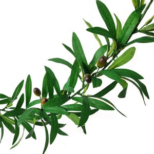 May include: A decorative artificial olive branch garland featuring elongated, pointed green leaves and small, round, dark brown olives attached to a flexible, thin stem. The foliage displays varied shades of green with visible vein details.