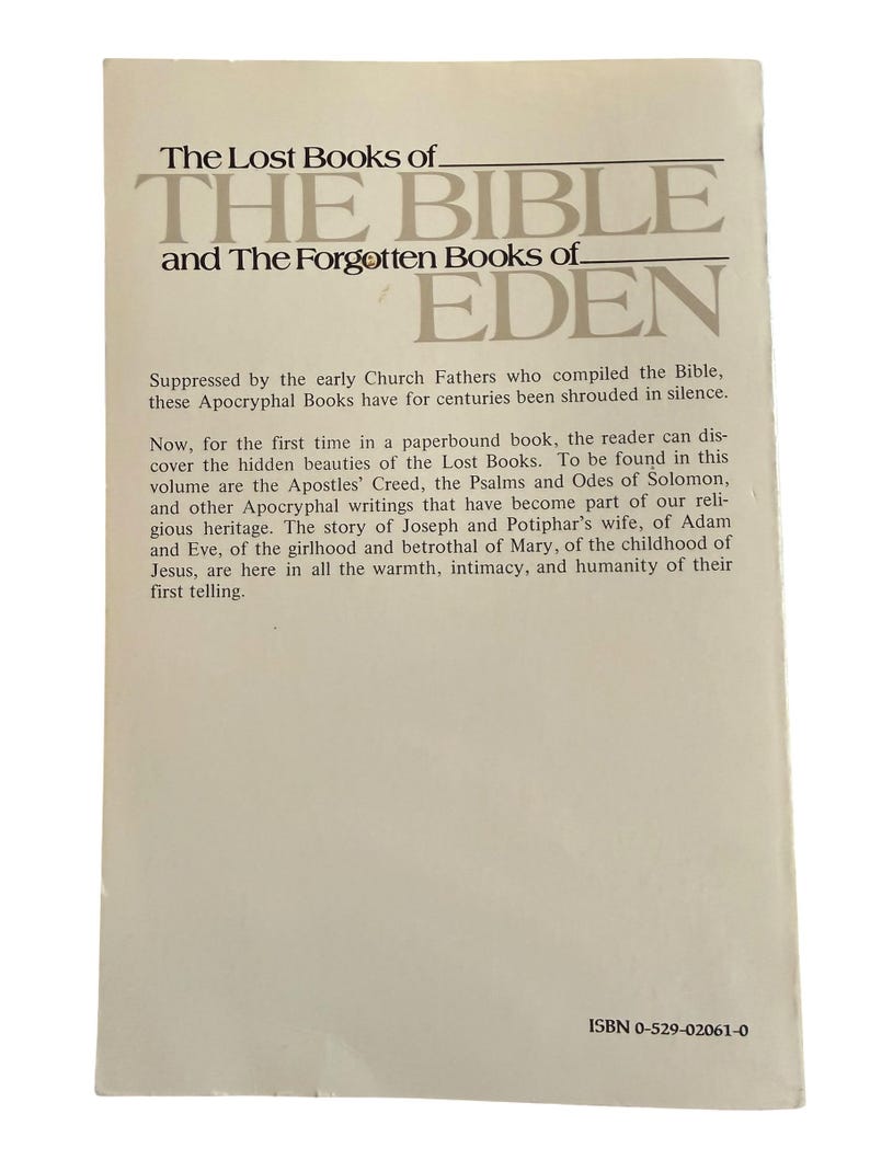 May include: A paperback book titled "The Lost Books of The Bible and The Forgotten Books of Eden." The cover is off-white with text in a dark grey font. The book's description is printed below the title, with the ISBN at the bottom.