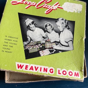 May include: A vintage "Loop Craft" weaving loom box. The box is lime green with red text reading "Loop Craft" and "Weaving Loom". A black and white photo shows three young girls weaving. The text "A creative hobby for the young and the young in heart" is also visible.