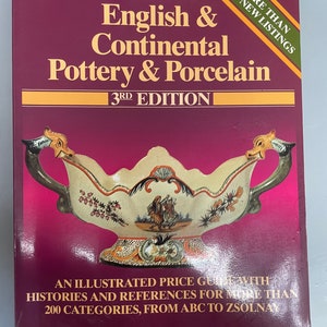 May include: A book titled "Warman's English & Continental Pottery & Porcelain 3rd Edition" with a cover image of a colourful porcelain bowl with floral and animal designs. The book is an illustrated price guide with histories and references for over 200 categories.