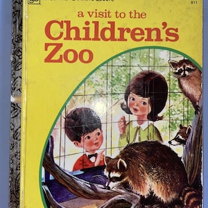 May include: A Little Golden Book titled "A Visit to the Children's Zoo" with a yellow cover. The cover art features two children looking at raccoons in a zoo setting. The book has a price tag of 39¢.