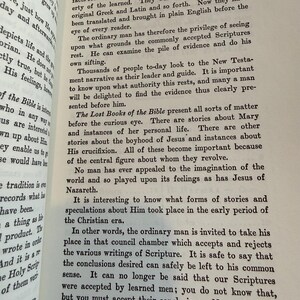 May include: An open book displaying the title "INTRODUCTION" and text discussing the translation of ancient texts. The pages are aged, with black text. The text explores the importance of examining the Scriptures.
