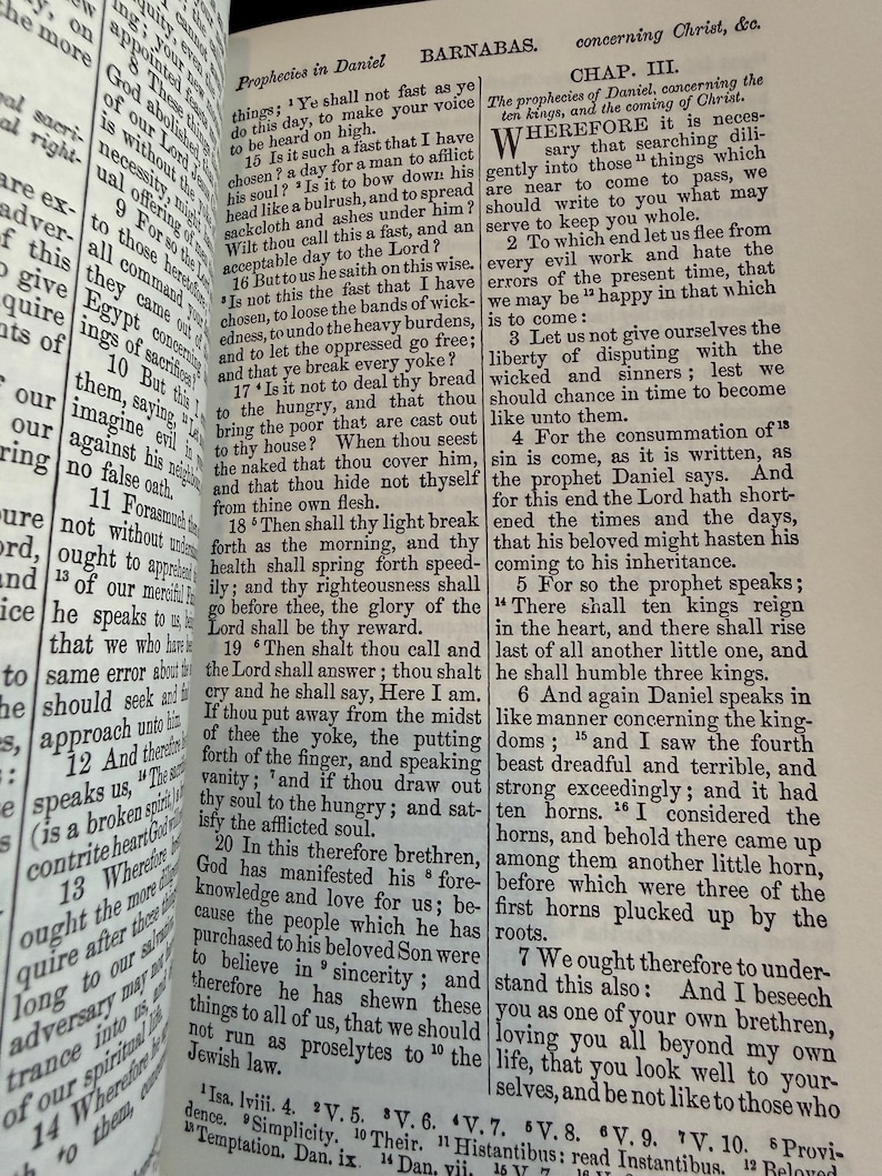 May include: An open book displaying text from the Bible, with the headings "Prophecies in Daniel" and "Barnabas." The pages are aged, and the text is printed in black ink. The book is open to a chapter with multiple verses.