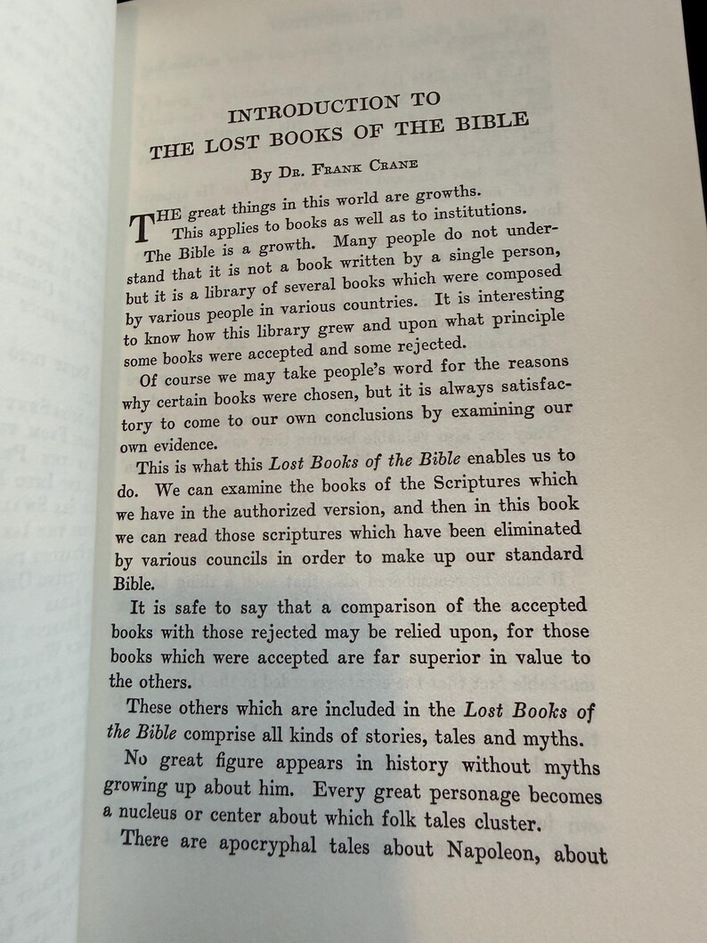 May include: An open book displaying the title "INTRODUCTION TO THE LOST BOOKS OF THE BIBLE" by Dr. Frank Crane. The text explores the evolution of the Bible, its compilation, and the inclusion of various stories and myths.