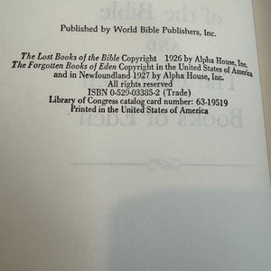 May include: An open book page featuring text from "The Lost Books of the Bible" and "The Forgotten Books of Eden." The text includes copyright details, ISBN, and Library of Congress catalog card number. Printed in the United States of America.