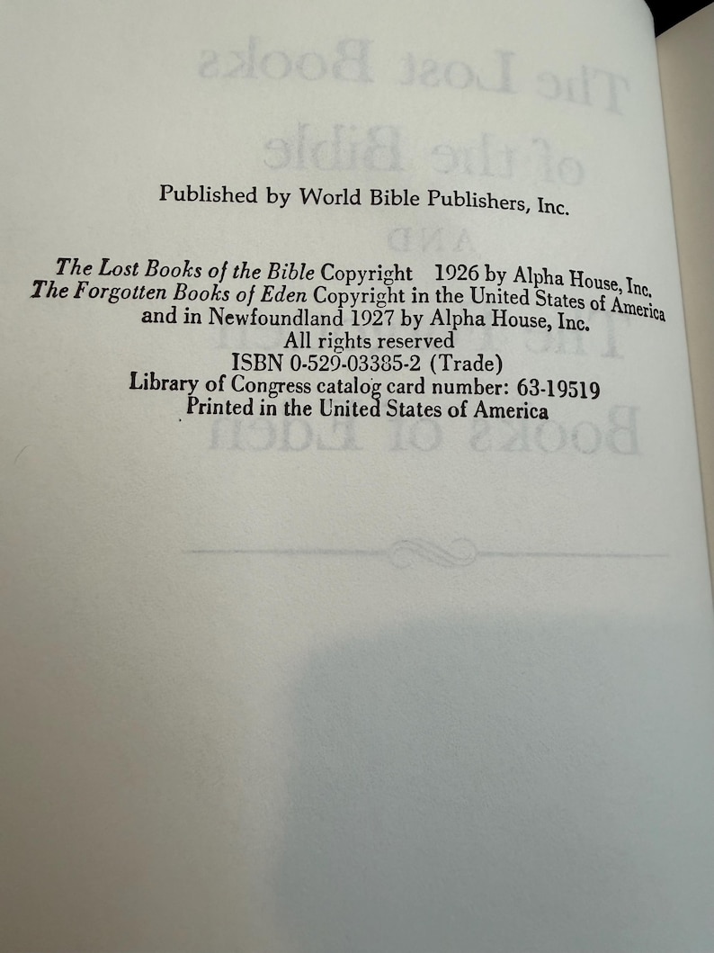 May include: An open book page featuring text from "The Lost Books of the Bible" and "The Forgotten Books of Eden." The text includes copyright details, ISBN, and Library of Congress catalog card number. Printed in the United States of America.