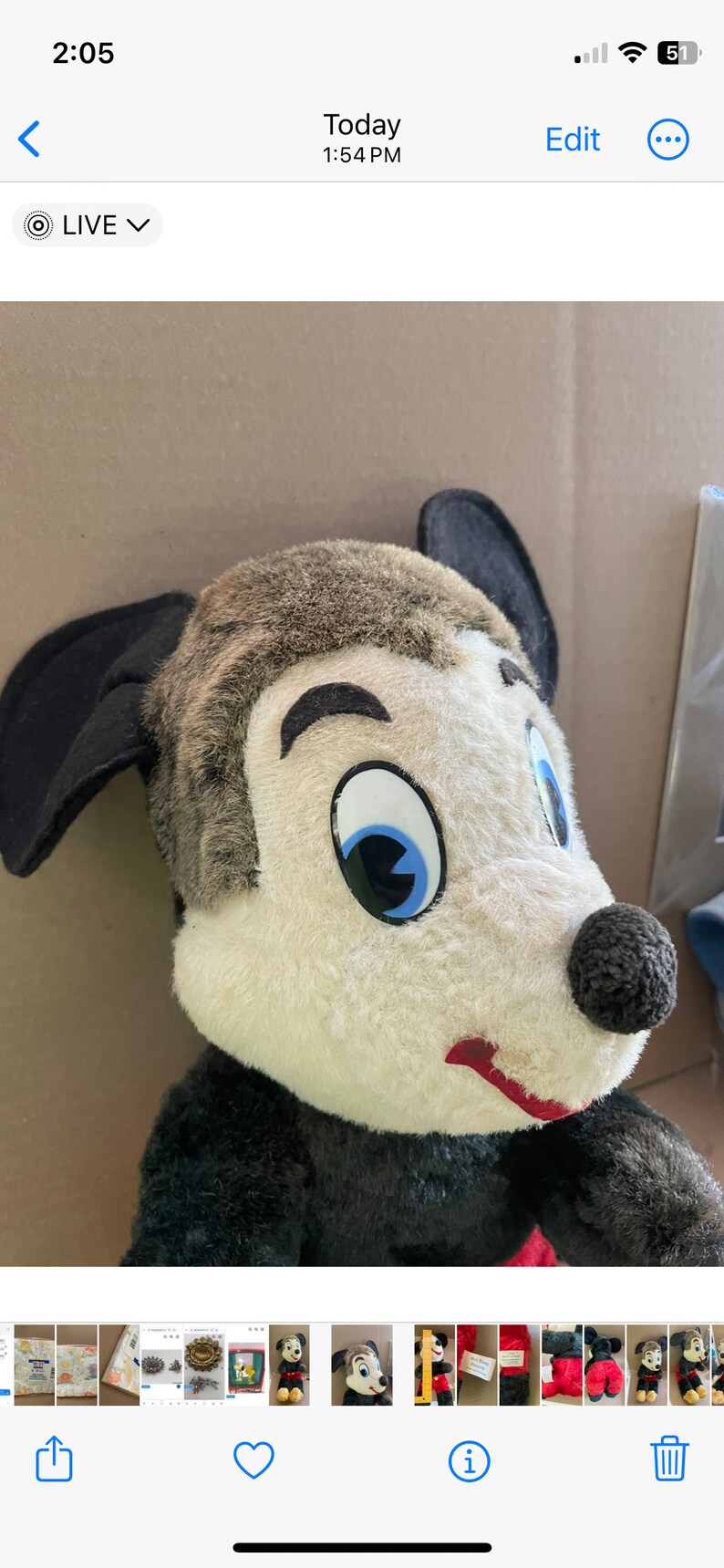 May include: A vintage plush toy of a cartoon character with black ears, a black nose, and a white face with a blue eye. The toy is wearing a black and red outfit.