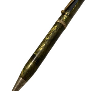 May include: A vintage green and gold mechanical pencil with a metal tip and a gold-toned clip.