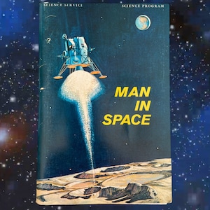 May include: A vintage book cover with a blue background and a yellow title "MAN IN SPACE". The cover features a spacecraft landing on the moon with a plume of smoke behind it. The book is part of a science program.