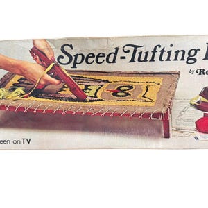 May include: A vintage Speed-Tufting Kit by Ronco box featuring a red tufting tool, a rectangular wooden frame with a partially completed owl rug design, red and green yarn balls, and printed instructions. The text reads Speed-Tufting Kit by Ronco.