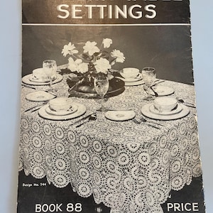 May include: Black and white image of a crocheted table cloth with a circular pattern. The table is set with plates, silverware, and glasses. The image is from a vintage book titled "Modern Table Settings" with the text "Book 88 Book 40 Revised + Enlarged Price 10¢".