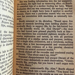 May include: Open book with text from a novel. The page shows a section titled "THE BLACK HOLE 3" with paragraphs of text. The text discusses scientific exploration and alien civilizations.