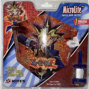 May include: A Yu-Gi-Oh! themed Microlite mylar kite with a 7-inch wingspan. The kite features a character graphic and the Yu-Gi-Oh! logo. Includes skytails and is ready to fly. Ages 5 to adult.