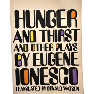 May include: A paperback book titled Hunger and Thirst and Other Plays by Eugene Ionesco, translated by Donald Watson. The cover is off-white with bold black lettering and small, colorful accents in orange, yellow, and purple within the letters.