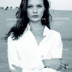 Può includere: Una fotografia in bianco e nero di una donna con lunghi capelli scuri che indossa una camicia bianca abbottonata. È in piedi con le braccia incrociate e tiene una sigaretta nella mano destra.