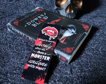 May include: A black and red bookmark with the text "What is more lovely after all, than a MONSTER undone with want?"  The bookmark features a red, open mouth with fangs.