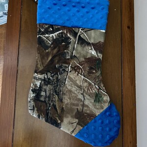 May include: Camouflage Christmas stocking with a blue fleece cuff and toe.