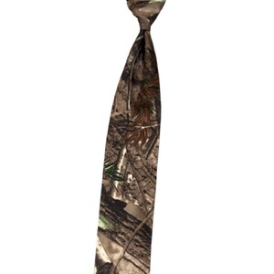 May include: A camouflage-patterned tie, with a knot and a long, pointed end. The tie features a mix of brown, green, and tan hues, creating a woodland camouflage design. The tie is designed for formal or semi-formal wear.