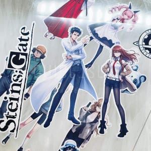 May include: A collection of anime character stickers. The stickers feature various characters in different poses, with a prominent sticker displaying the text "Steins;Gate". The characters are depicted in a variety of outfits and styles, with a mix of colors.