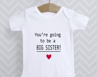 You're going to be a Big Sister Announcement Reveal Baby Grow Bodysuit Babygrow Vest Top Baby Shower Gift Sis - Choice of heart colours