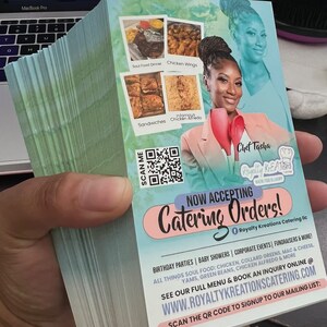 May include: A stack of rectangular catering flyers with a light green background. The flyer features a photo of a chef, images of food, a QR code, and text including "Now Accepting Catering Orders!", "Chef Tasha", "Royalty Kreations", and the website URL.