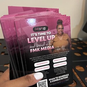 May include: A stack of rectangular marketing flyers with a dark pink and black colour scheme. The text reads IT'S TIME TO LEVEL UP and brand with FMK MEDIA. It features a photo of a person, a QR code, and a list of services including headshots, website design, graphic design, and business coaching.