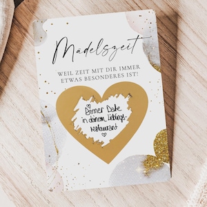 Può includere: Un biglietto rettangolare con il testo in tedesco Madelszeit e Weil Zeit mit dir immer etwas besonderes ist. Il biglietto presenta un'area grattabile a forma di cuore dorato con il testo scritto a mano Dinner Date in deinem Lieblings-Restaurant.